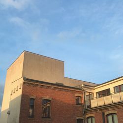 Low angle view of building against cloudy sky