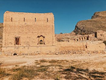 Old ruins of building against clear sky