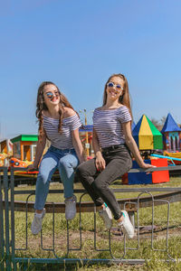 Gen z girls enjoying outdoors, expressing positive emotions. outdoor photo of two girl friends 