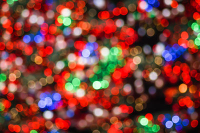 Defocused image of illuminated christmas lights at night