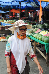 Full length portrait of a man in market