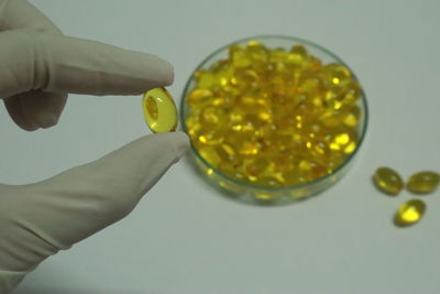 Close-up of hand holding yellow leaf