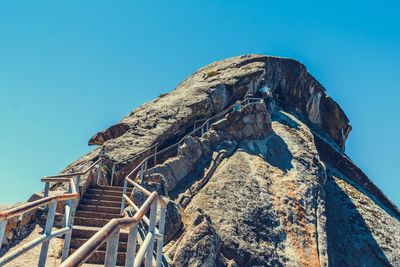 Low angle view of old ruins against clear blue sky