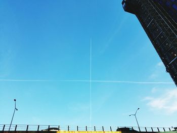 Low angle view of power lines against blue sky