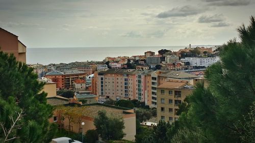 High angle view of townscape by sea against sky