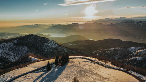 Scenic view of snowcapped mountains against sky during sunset