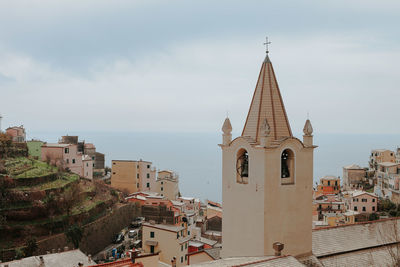 View of bell tower in city against sky