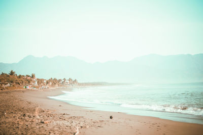 Scenic view of beach against clear sky