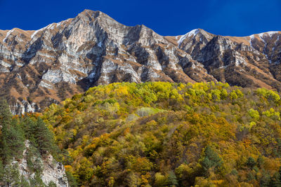 Autumn in the mountains. scenic view of mountains against sky during autumn