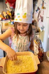 Portrait of cute girl cooking food