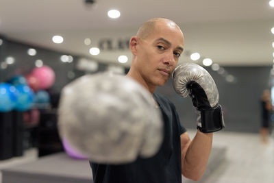 Close-up of man lifting dumbbell in gym