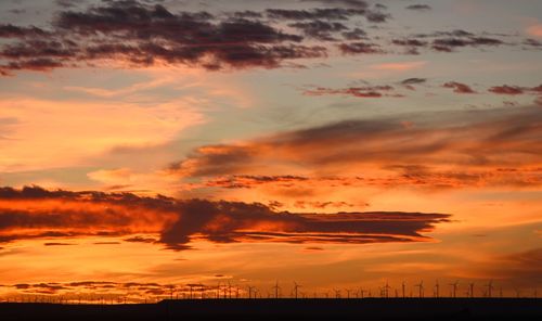 Scenic view of dramatic sky over landscape during sunset