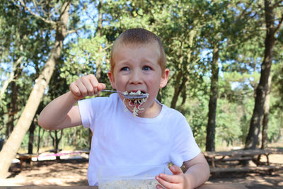 Portrait of young woman holding ice cream