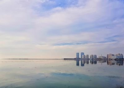 Scenic view of sea and buildings against sky