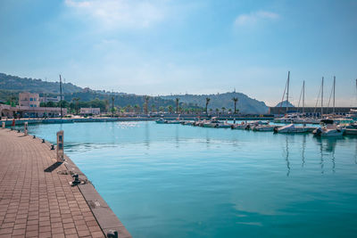 Sailboats moored in harbor