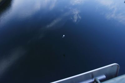 Airplane flying over sea against blue sky