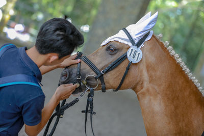 Rear view of man riding horse