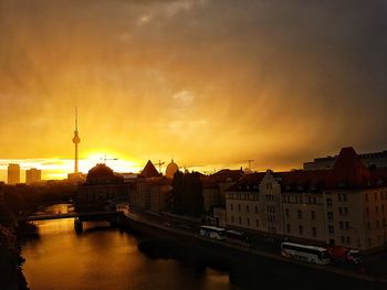 View of cityscape against cloudy sky at sunset