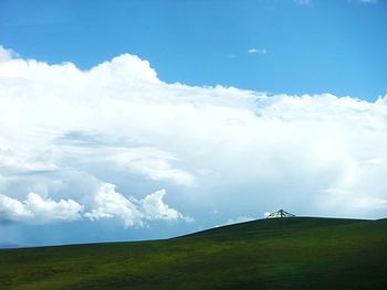 Scenic view of landscape against cloudy sky