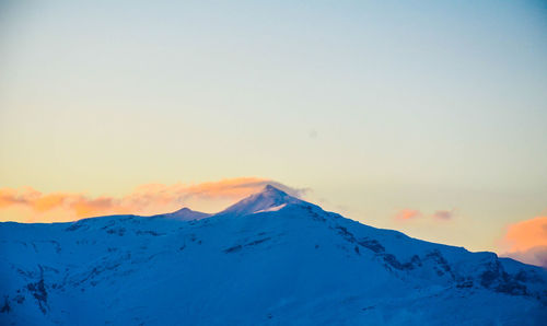 Scenic view of snowcapped mountains against clear sky