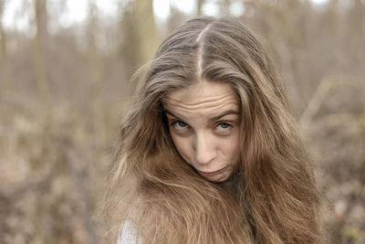 Close-up portrait of teenage girl in forest