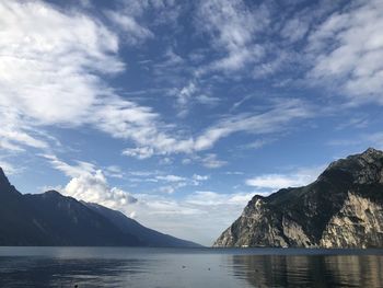 Scenic view of sea and mountains against sky