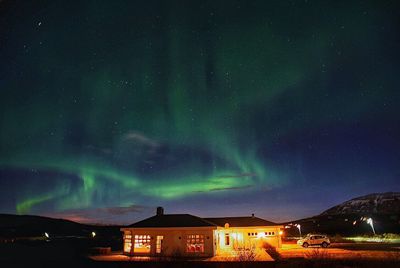 Illuminated built structure against sky at night