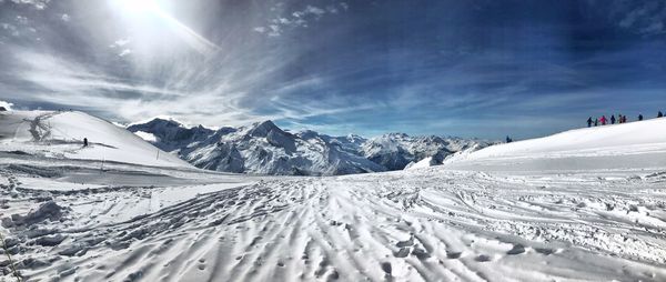 Scenic view of snow covered mountains against sky