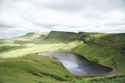 Scenic view of llyn y fan fach lake against sky