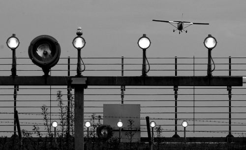 Low angle view of illuminated street light against sky