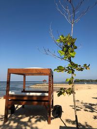 Built structure on beach against clear blue sky