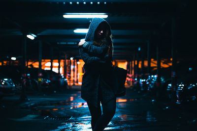 Woman walking in basement at night