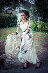 Young woman standing by decoration in park