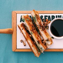 Directly above view of bread and black coffee served in tray on table