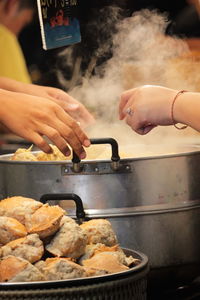 Midsection of people preparing food