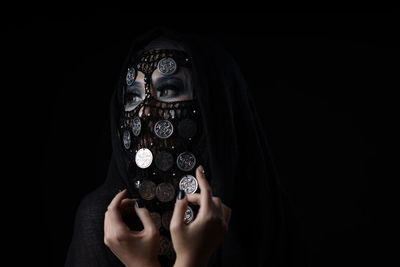 Portrait of a young woman holding black background