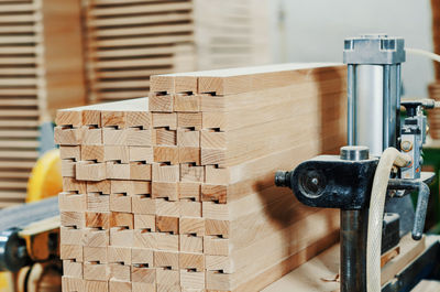 Stack of wooden bars in carpentry workshop. woodworking industry.