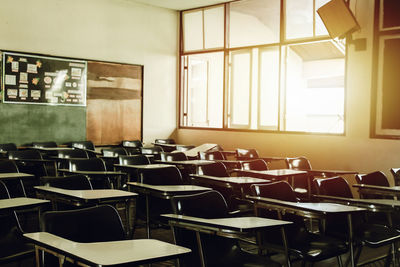 Empty chairs and tables in classroom