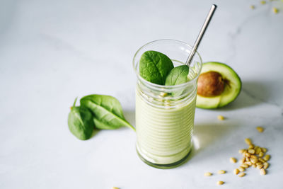 Vegan drink, detox diet smoothie with avocado and vegetables, spinach.