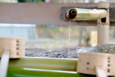 Close-up of bamboo dipper water fountain with ladles