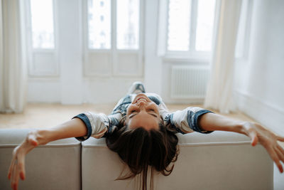 Side view of boy with arms raised