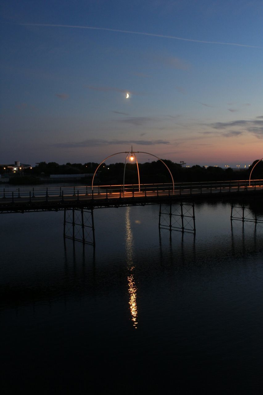 water, reflection, sunset, illuminated, built structure, waterfront, sky, architecture, lake, tranquility, night, silhouette, river, tranquil scene, scenics, dusk, connection, beauty in nature, nature, standing water