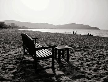 Chairs on beach against sky