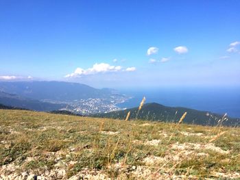 Scenic view of mountains against blue sky
