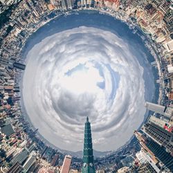 Aerial view of buildings against cloudy sky