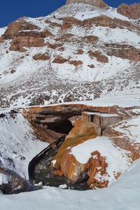 Built structure on snow covered rock