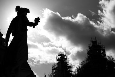 Low angle view of silhouette man against cloudy sky