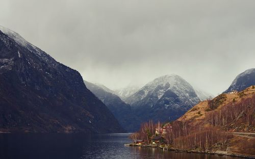 Scenic view of lake and mountains against sky