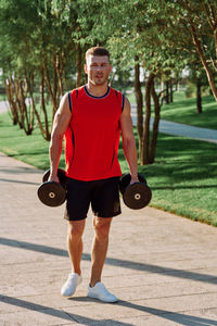 Portrait of young woman exercising in gym