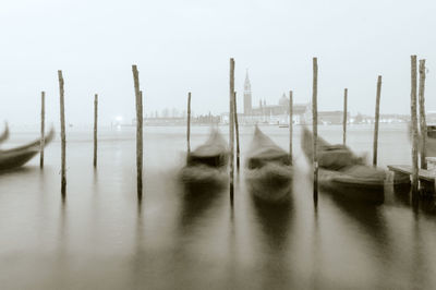 Panoramic view of wooden post in sea against clear sky